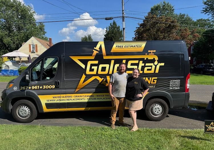 Two people stand by a van with 