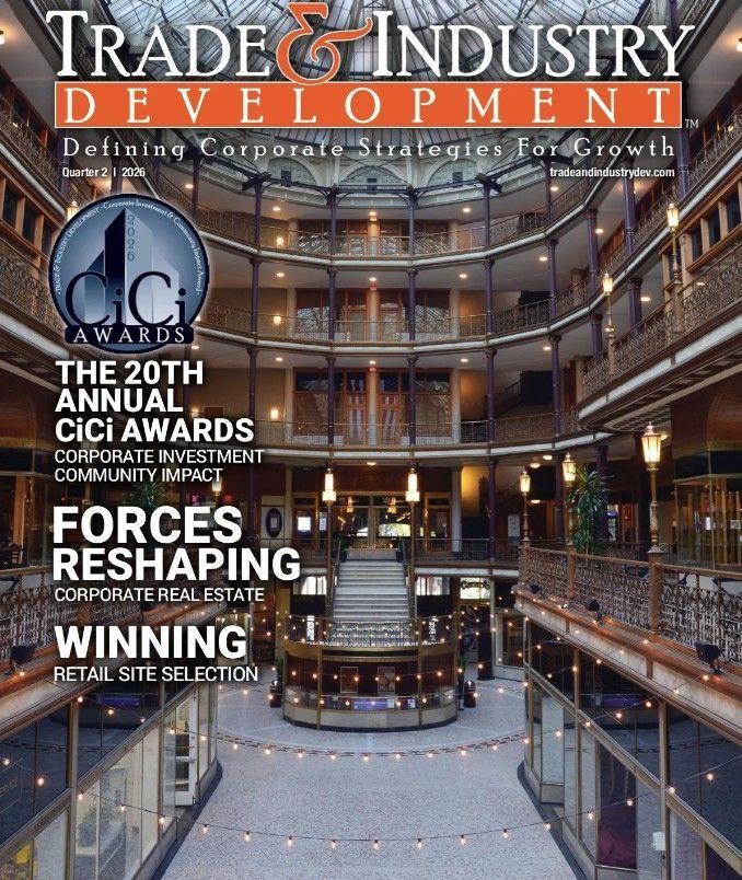 Trade & Industry Development magazine cover with a worker welding metal in a factory, red and black layout