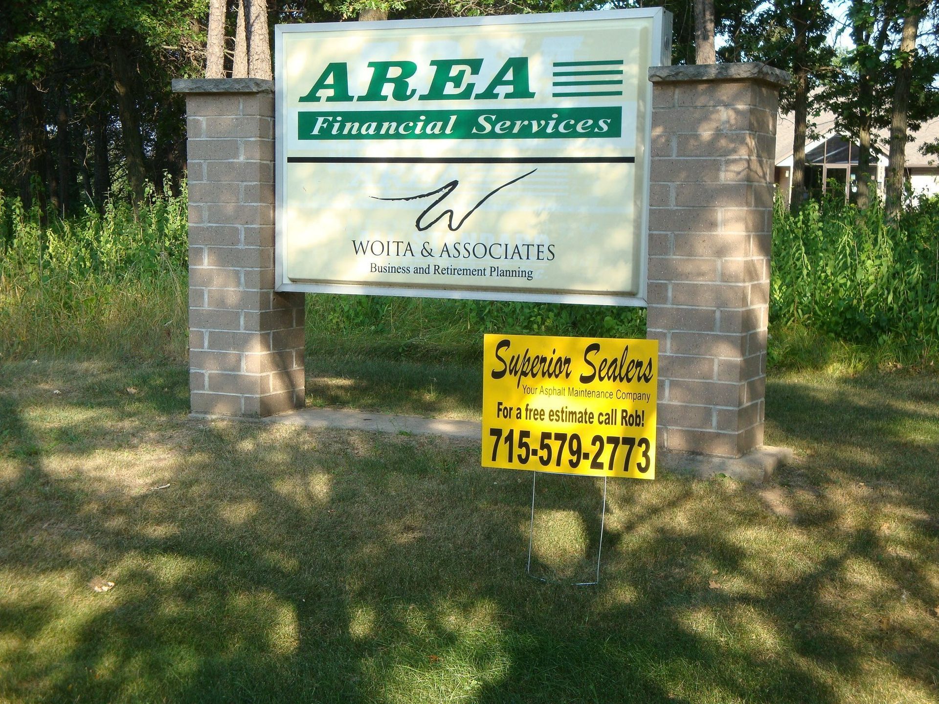 Sign for Area Financial Services. Yellow sign below for Seimor Seniors: 715-579-2773.