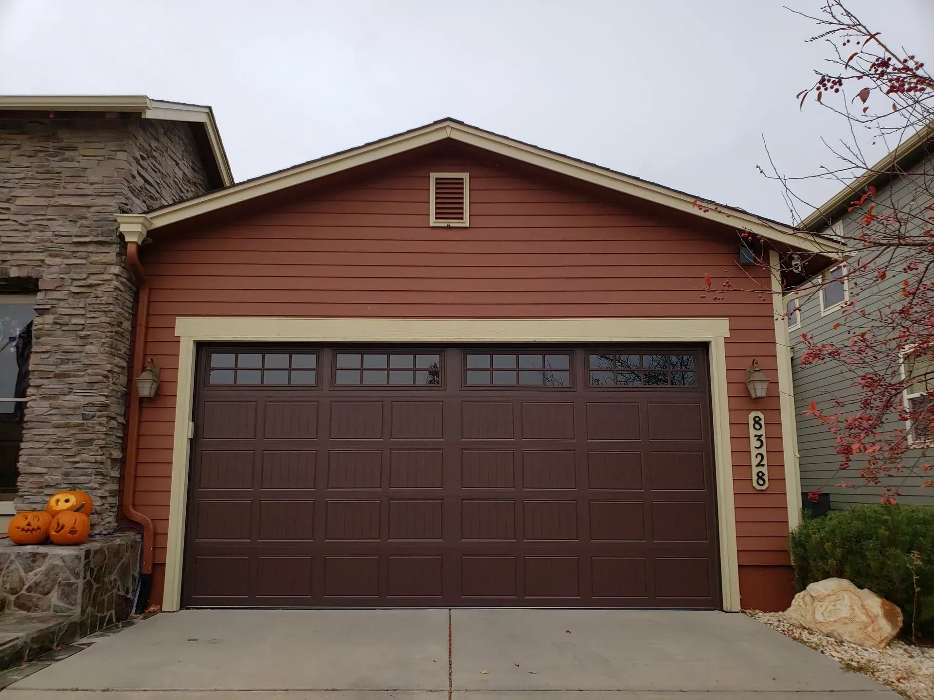 Brown garage with brown door, tan trim, and address 6726.