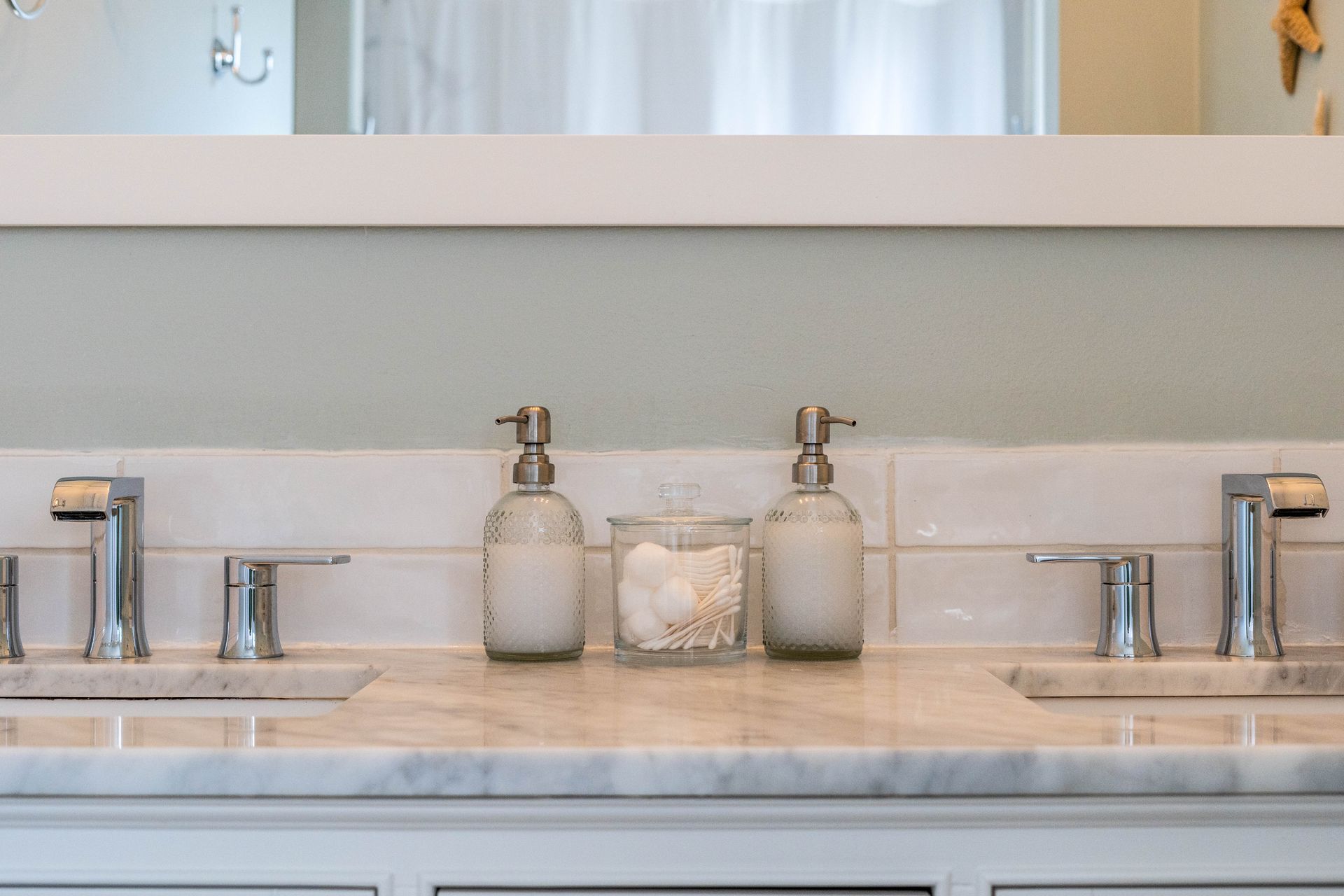 A bathroom sink with two sinks and a mirror.