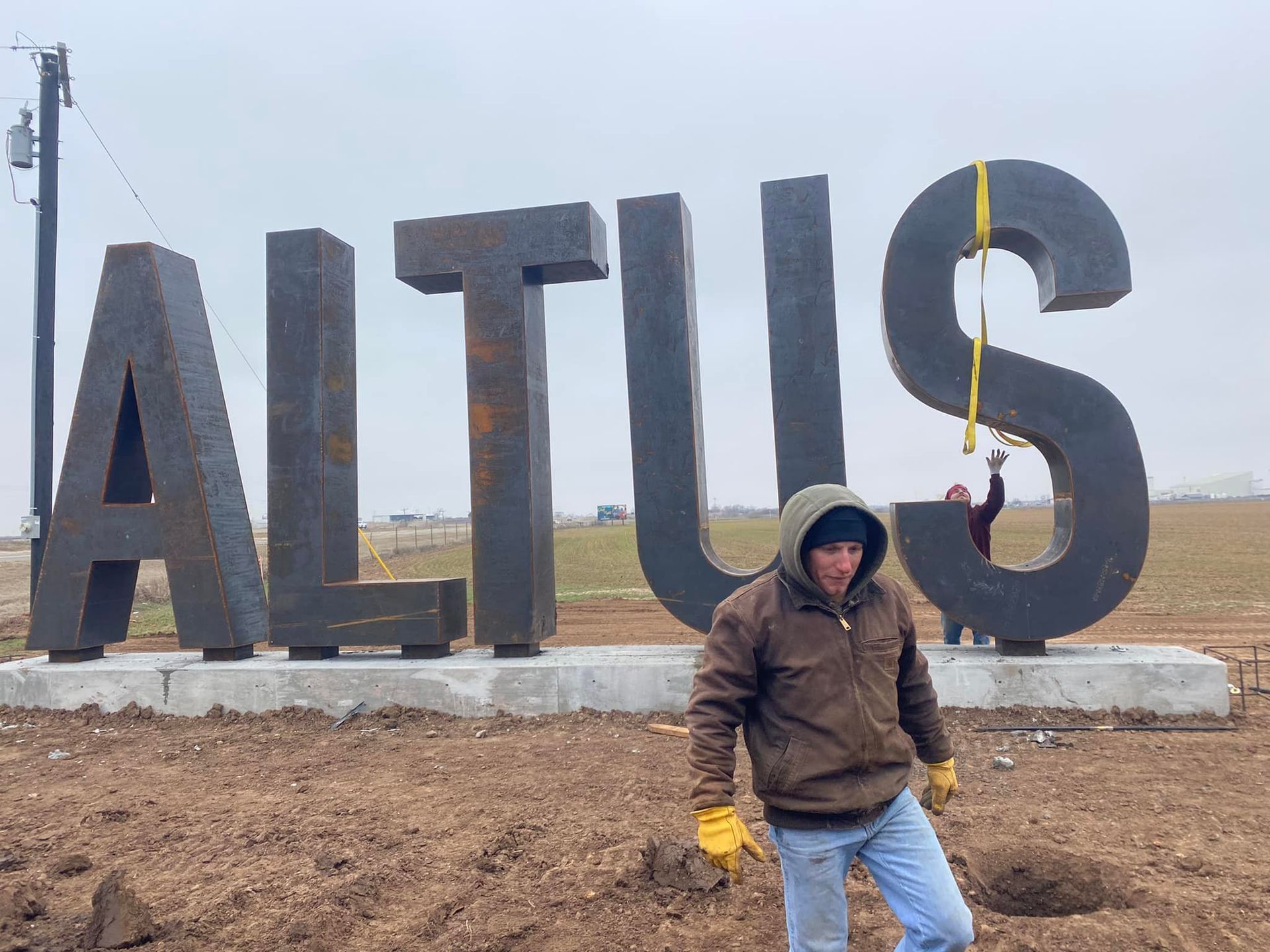A man stands in front of the large, metal 