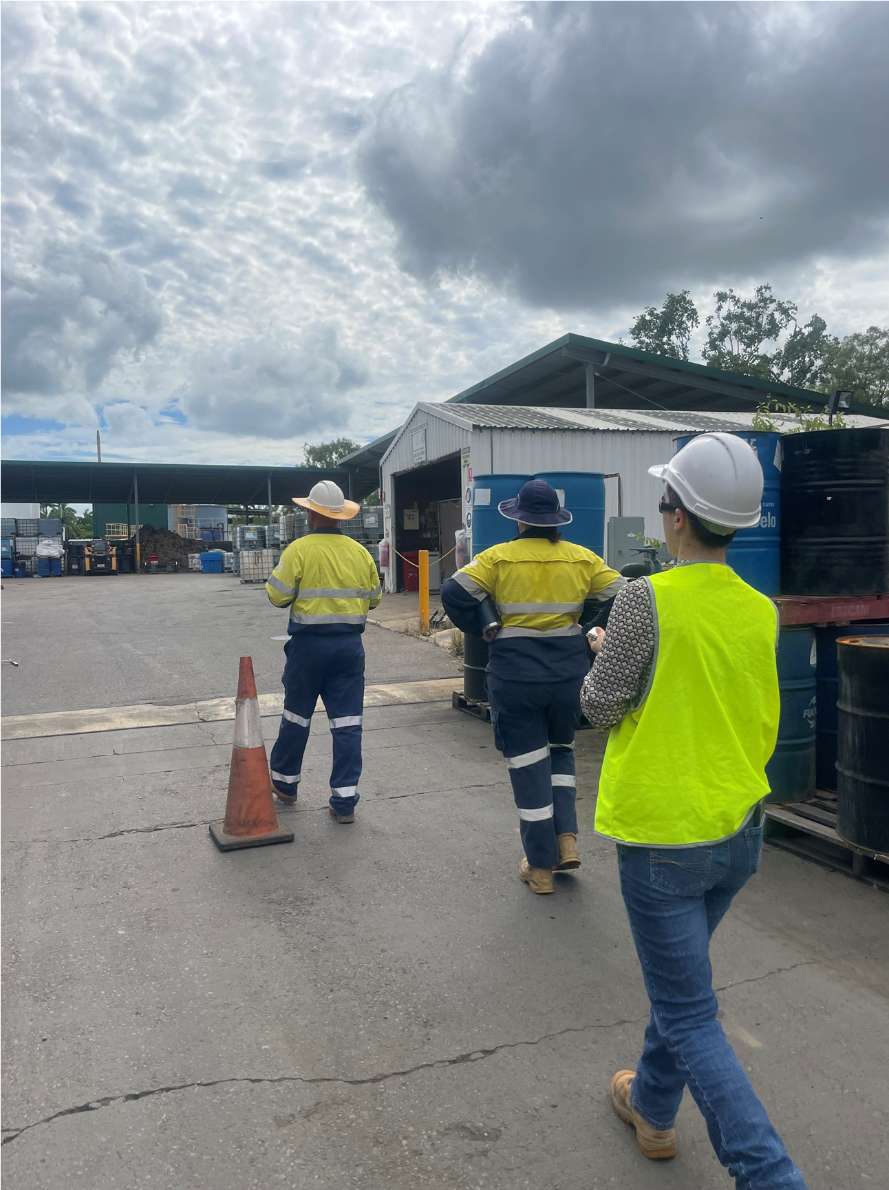 A group people walking through a waste facility.