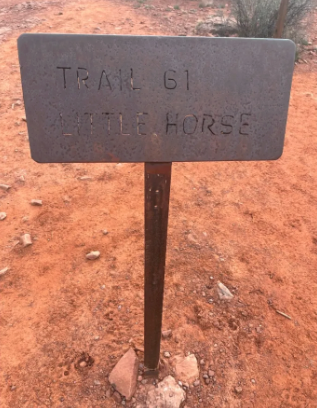 A sign that says trail 61 little horse on it