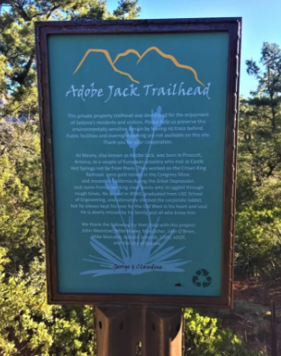 A sign that says adobe jack trailhead on it