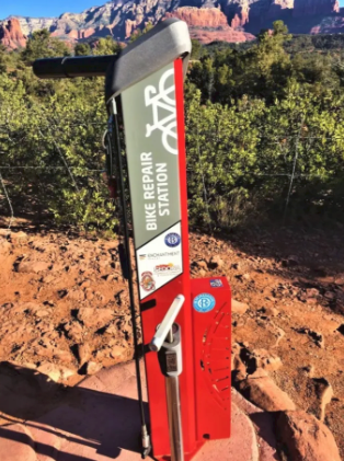 A red bike repair station with a mountain in the background