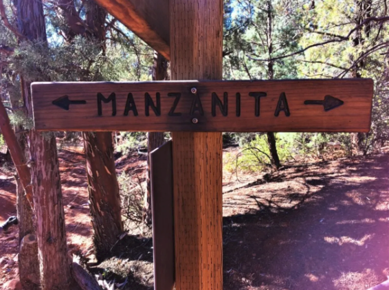 A wooden sign points the way to manzanita