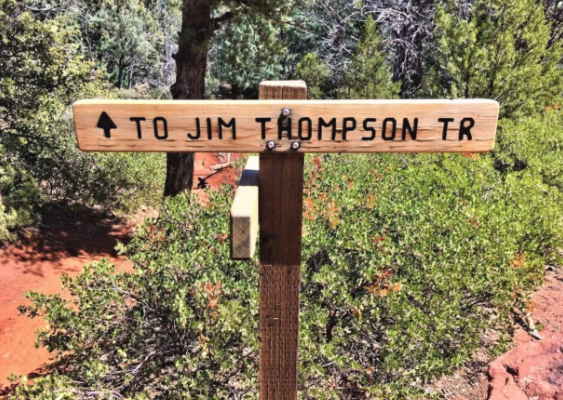 A wooden sign that says to jim thompson tr