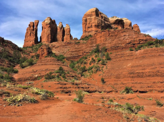 A large rock formation in the middle of a desert.