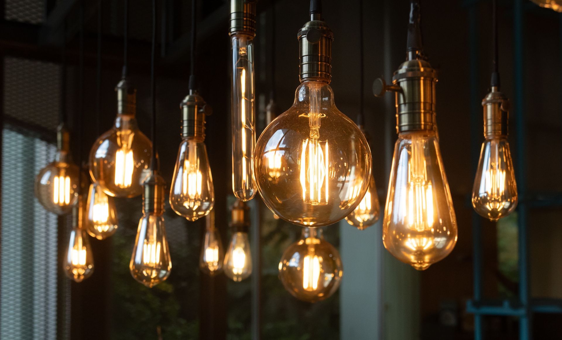 Warm vintage Edison bulbs hanging in a dim industrial setting