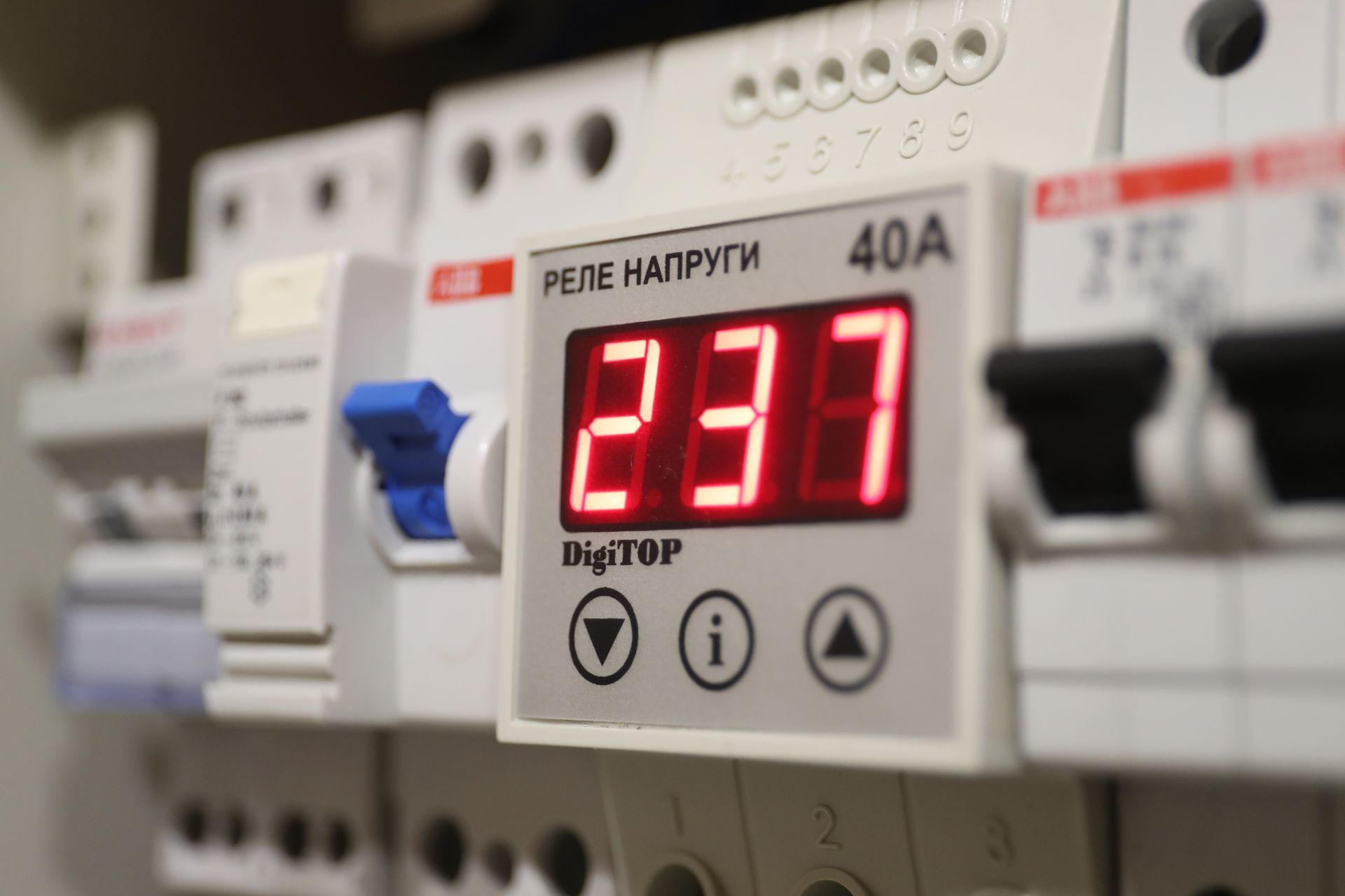 Digital electrical control panel with red “237” display and white breakers in the background