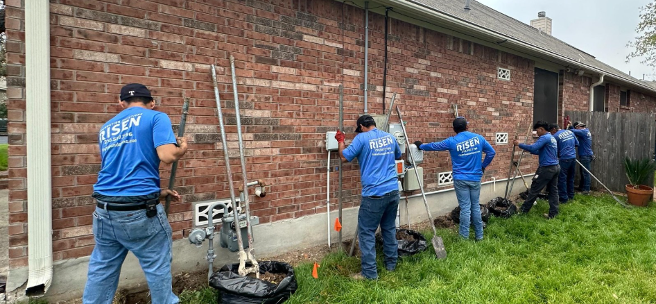 A group of men is working on a house foundation. A group of men is working on a house foundation.