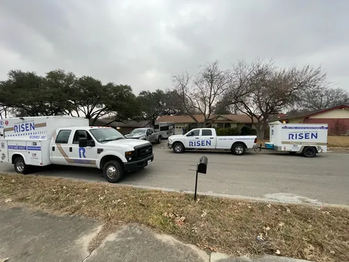 A couple of trucks parked on the side of the road.
