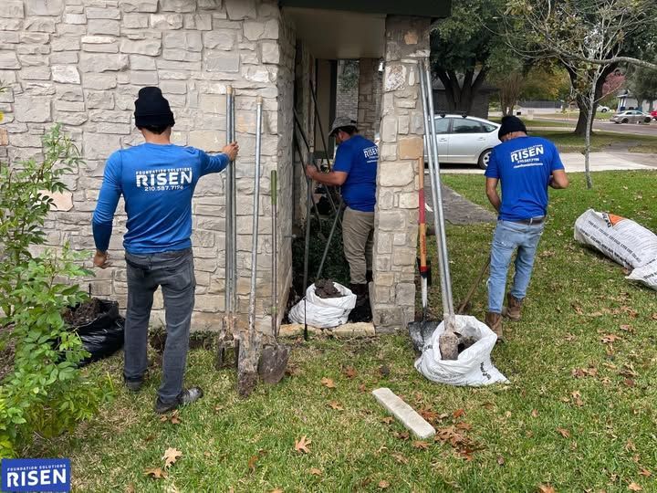 Three workers in blue shirts with 