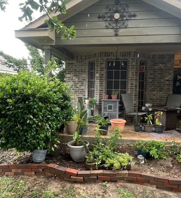 A house with lots of potted plants in front of it Converse tx with foundation repair