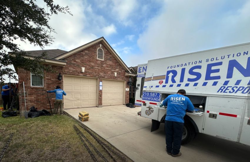 A white truck is parked in front of a brick house. A white truck is parked in front of a brick house.
