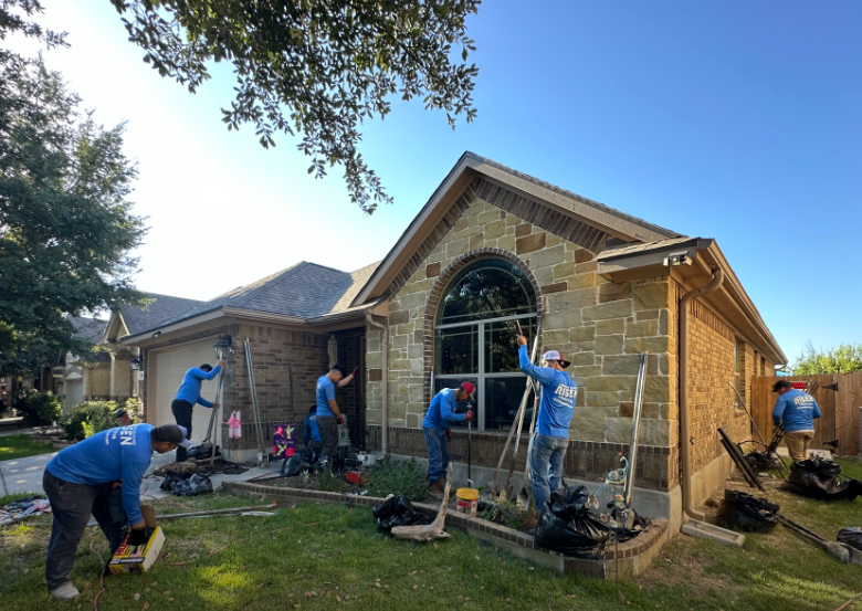 A group of men are working on a house.