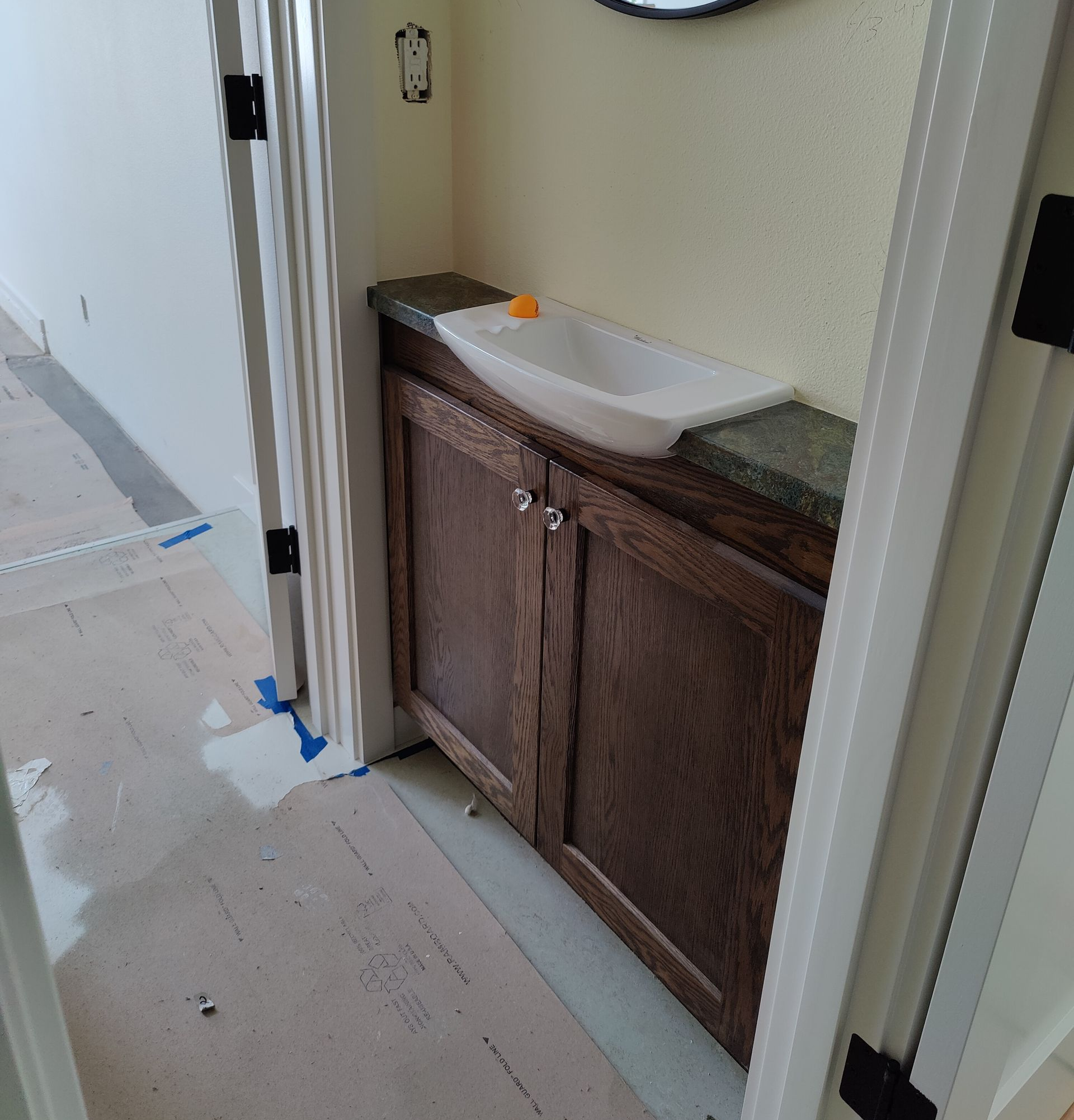 Wooden storage cabinets under a staircase with white steps and railing Wooden storage cabinets under a staircase with white steps and railing