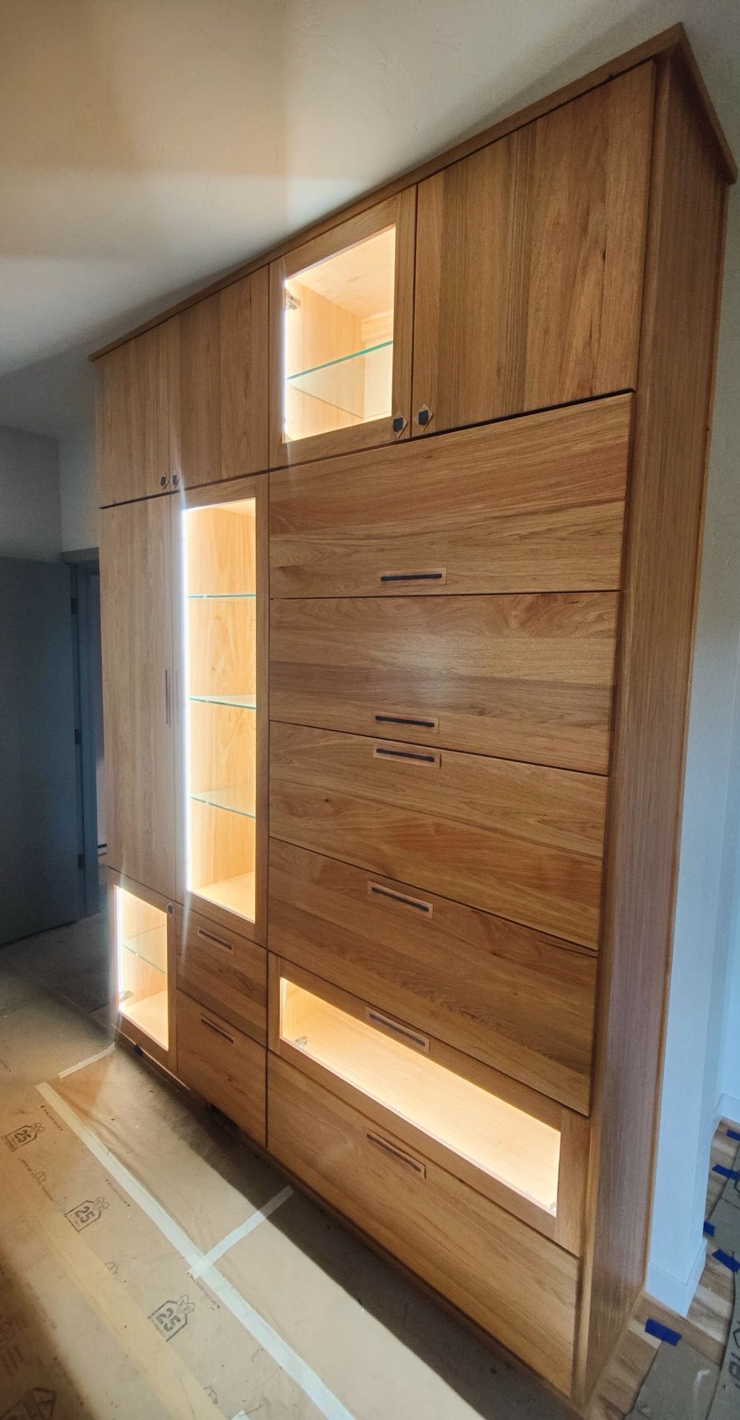 Built-in white storage cabinets in an attic, utilizing sloped ceiling space Built-in white storage cabinets in an attic, utilizing sloped ceiling space