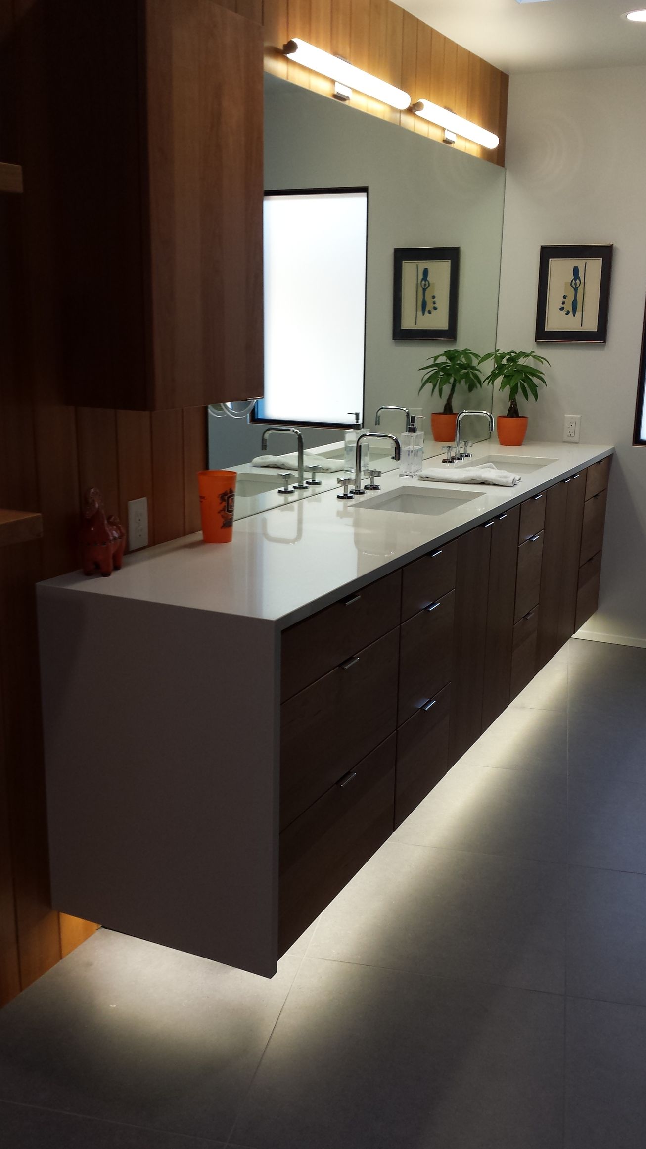 Modern bathroom with wood paneling, and a separate toilet area