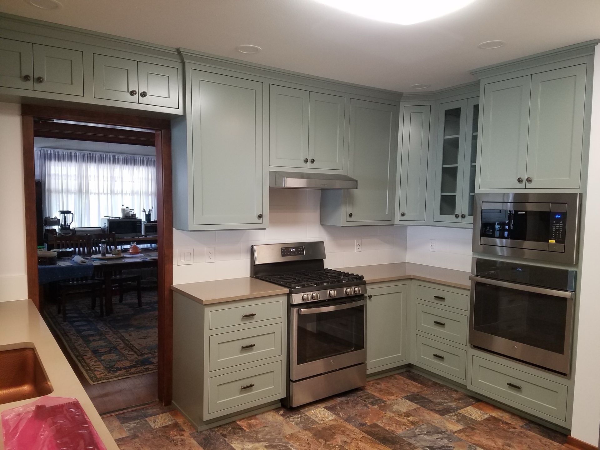 Wooden kitchen cabinets with built-in oven and textured backsplash Wooden kitchen cabinets with built-in oven and textured backsplash