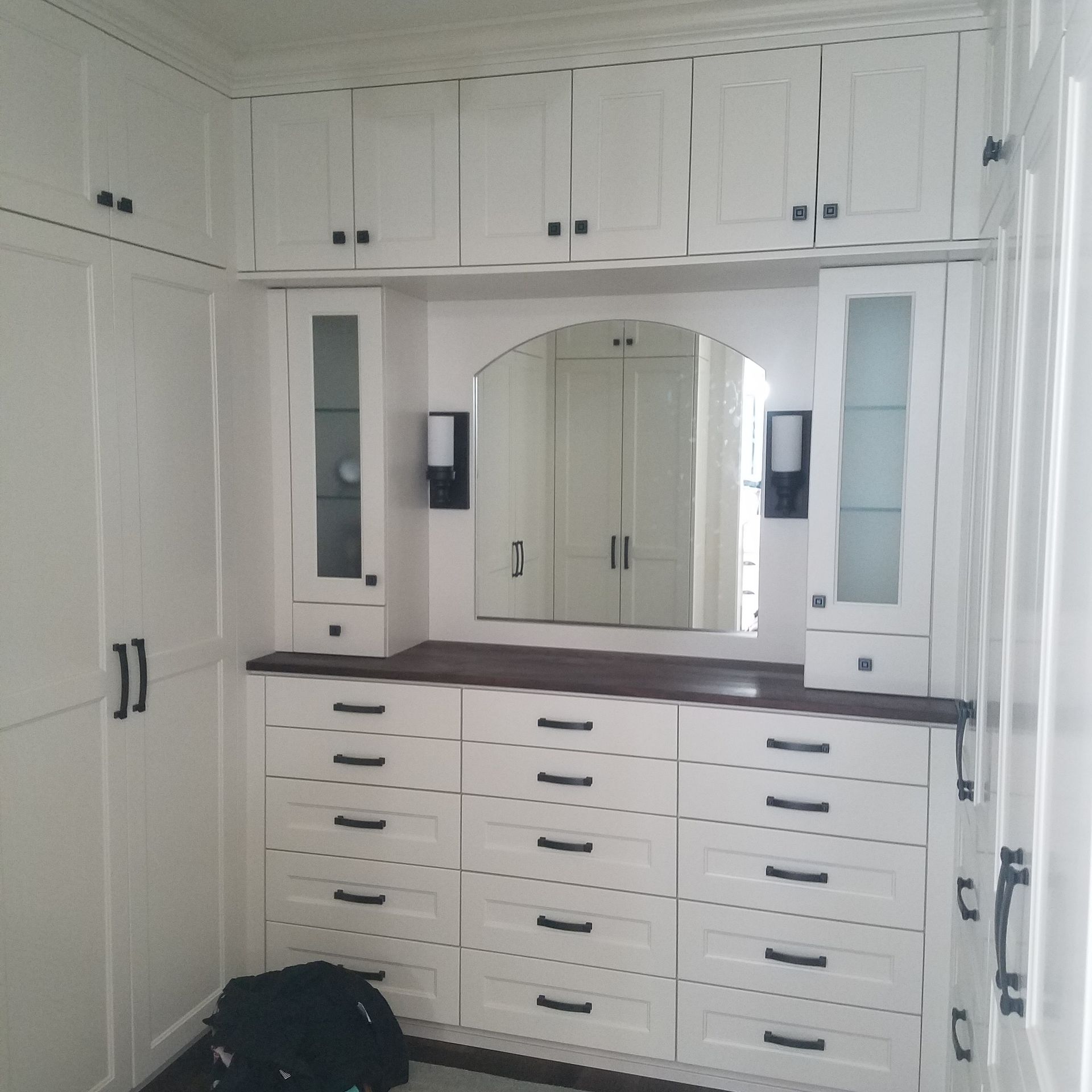 Walk-in closet with built-in wooden shelving for clothes Walk-in closet with built-in wooden shelving for clothes