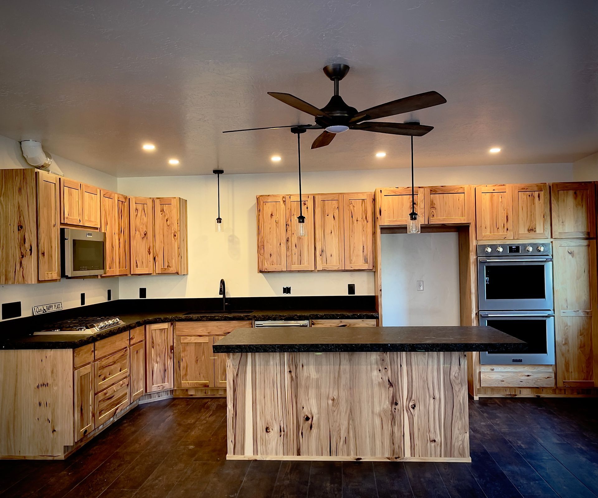 Modern kitchen with light wood cabinets and stainless steel appliances