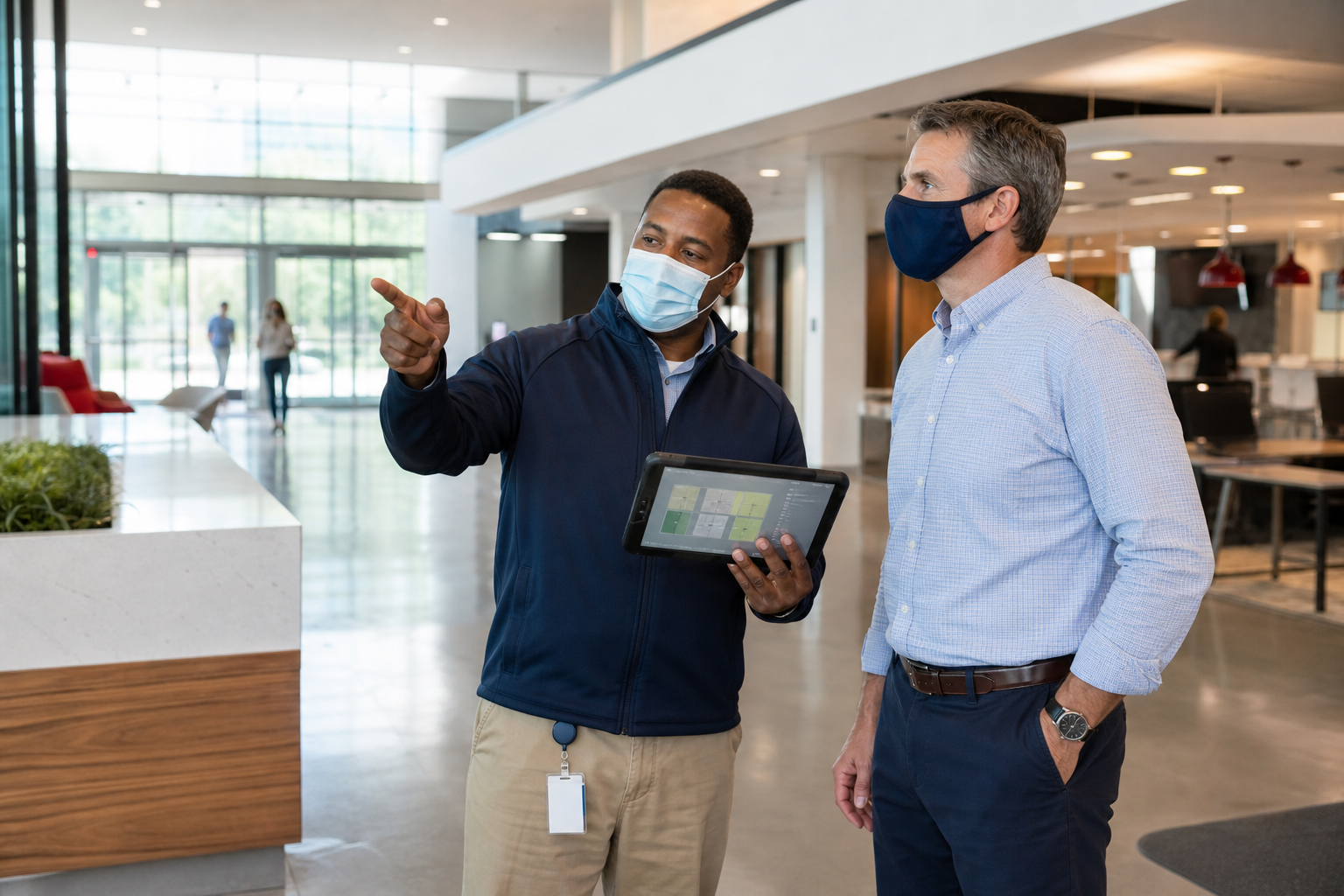 Facility manager and cleaning supervisor reviewing a workplace cleaning plan