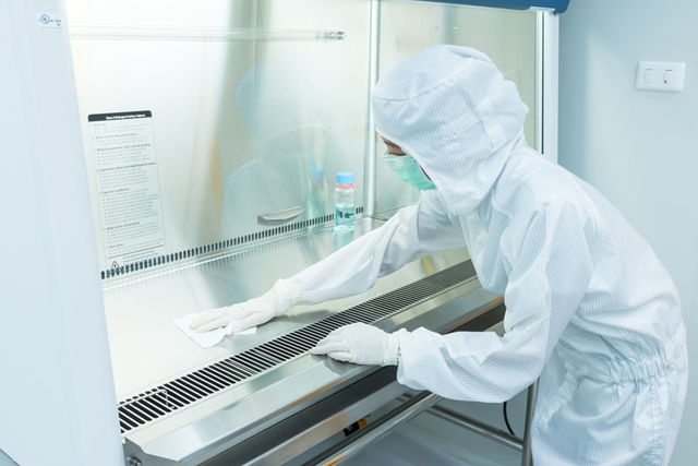 Controlled-environment professional working inside a cleanroom