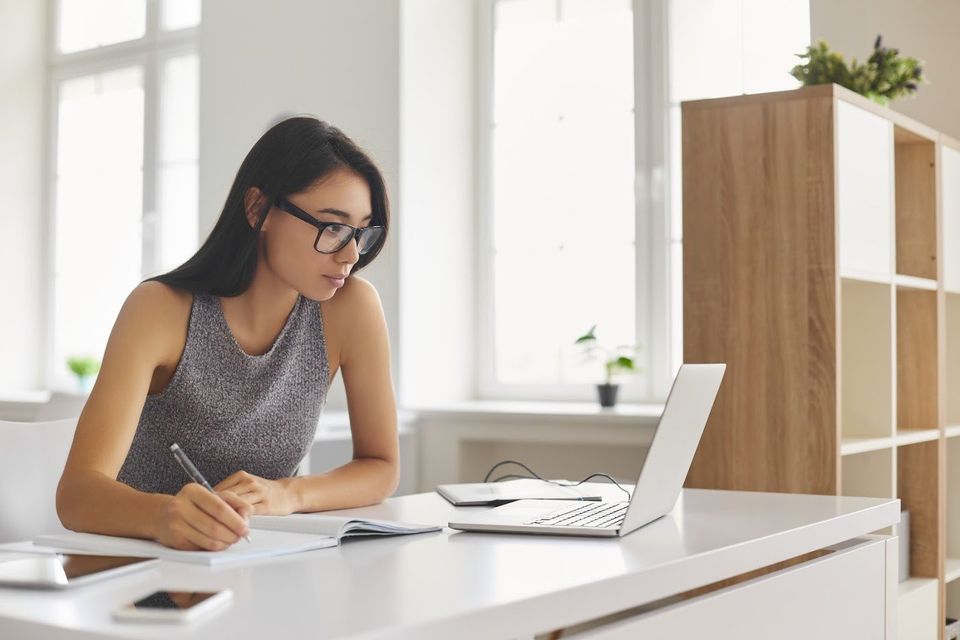 Woman Writing on Notebook — Atlanta, GA — Cleanstar National, Inc.