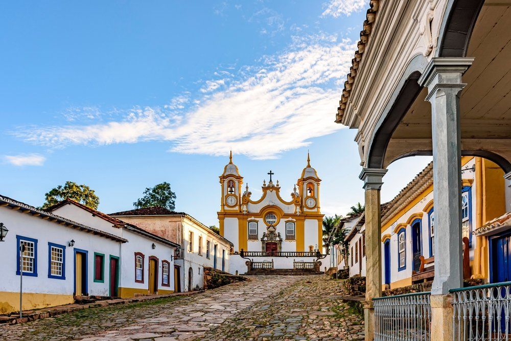 Uma fileira de edifícios com uma igreja ao fundo.
