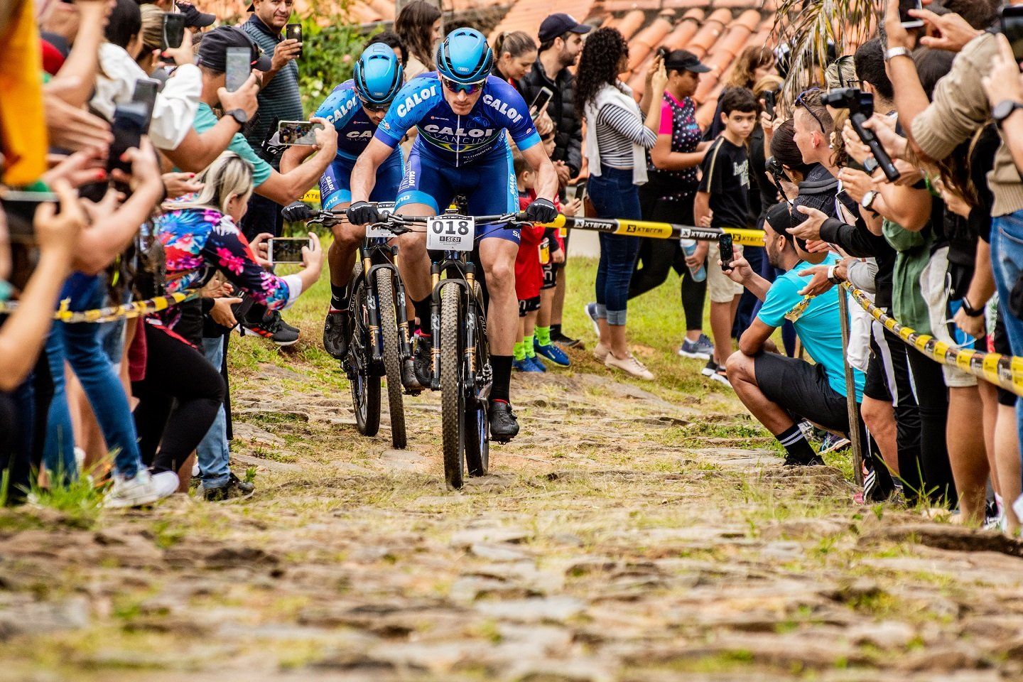 Um grupo de pessoas está andando de bicicleta por uma estrada de terra.