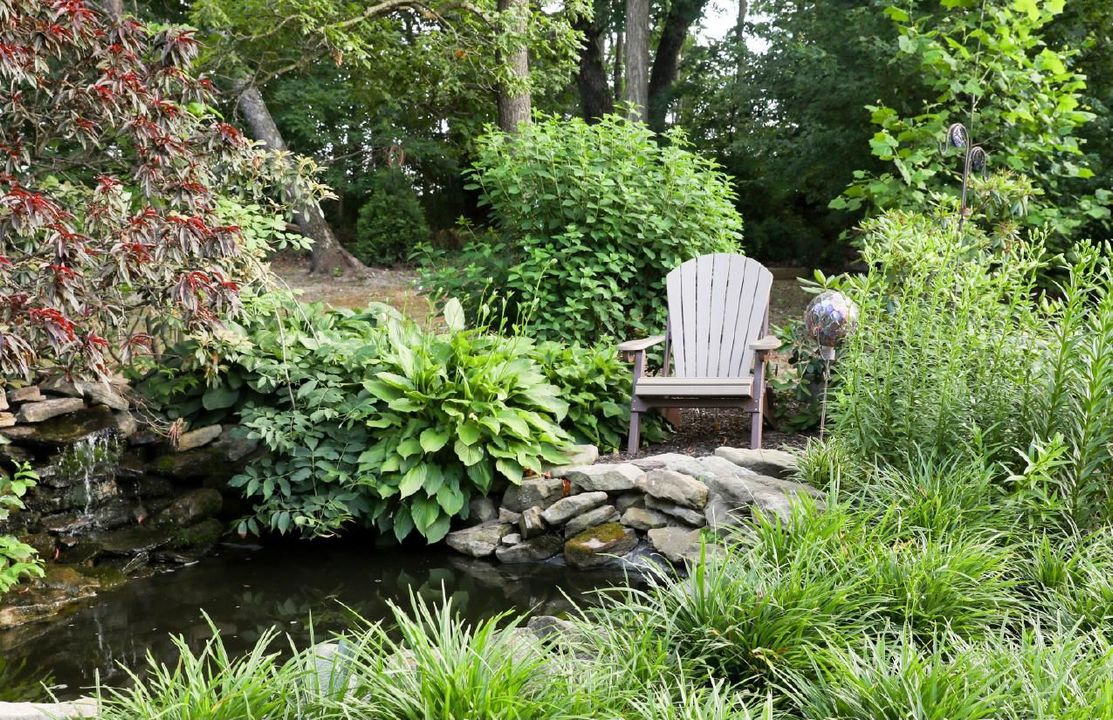 folding Adirondack chair shown in weatherwood/tudor brown