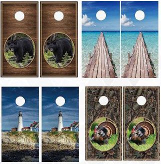 A set of cornhole boards with a bear , lighthouse , and turkey on them.
