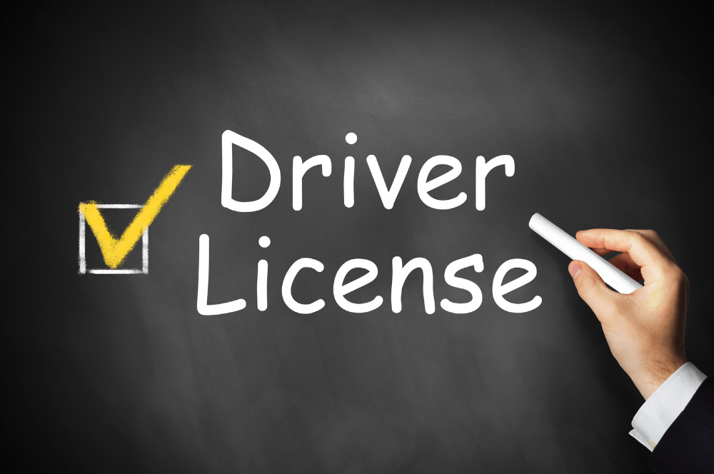 Chalkboard reading “Driver License” with a checked box and a hand writing a check mark
