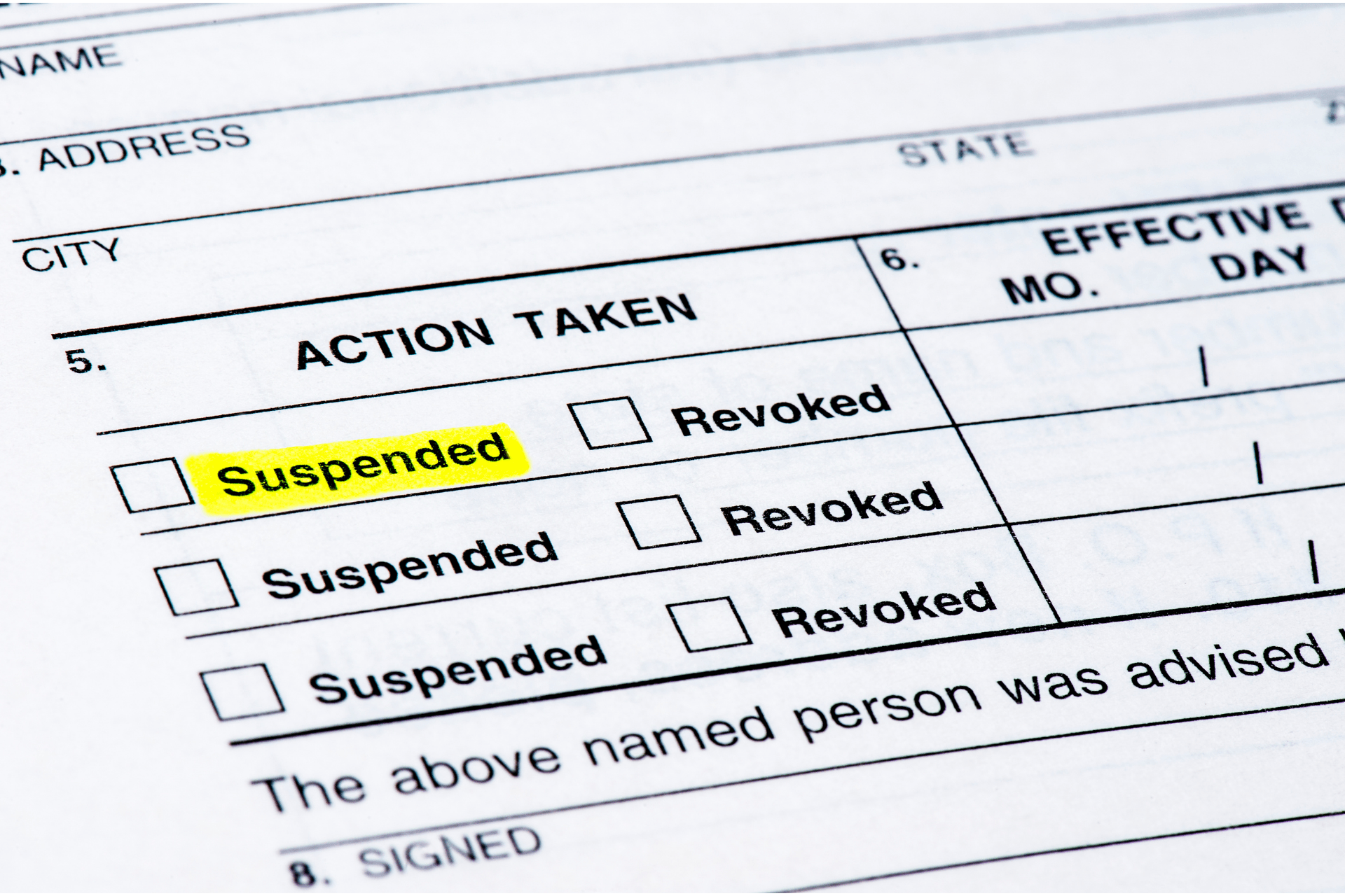 Form with “Suspended” highlighted in yellow and checkboxes for suspended or revoked actions