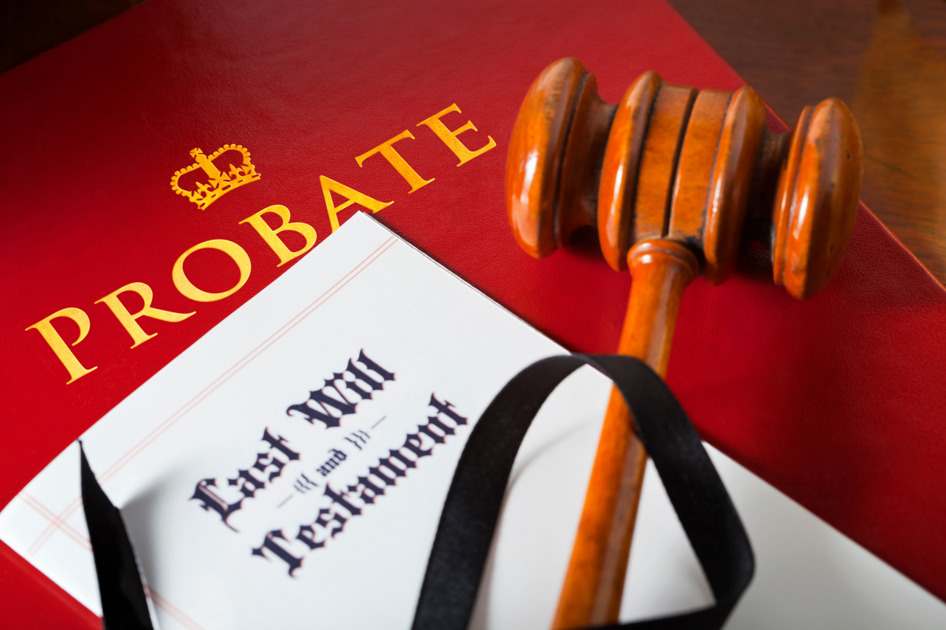 Probate documents with “Last Will and Testament” and a gavel on a red background
