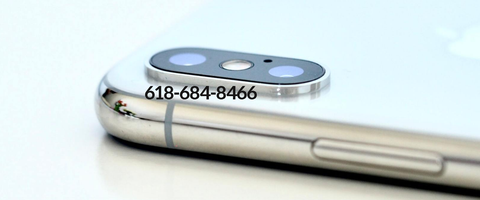 Close-up of a smartphone screen and edge showing a phone number on display