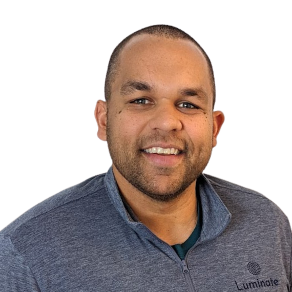 Smiling man in a blue-gray jacket against a white background