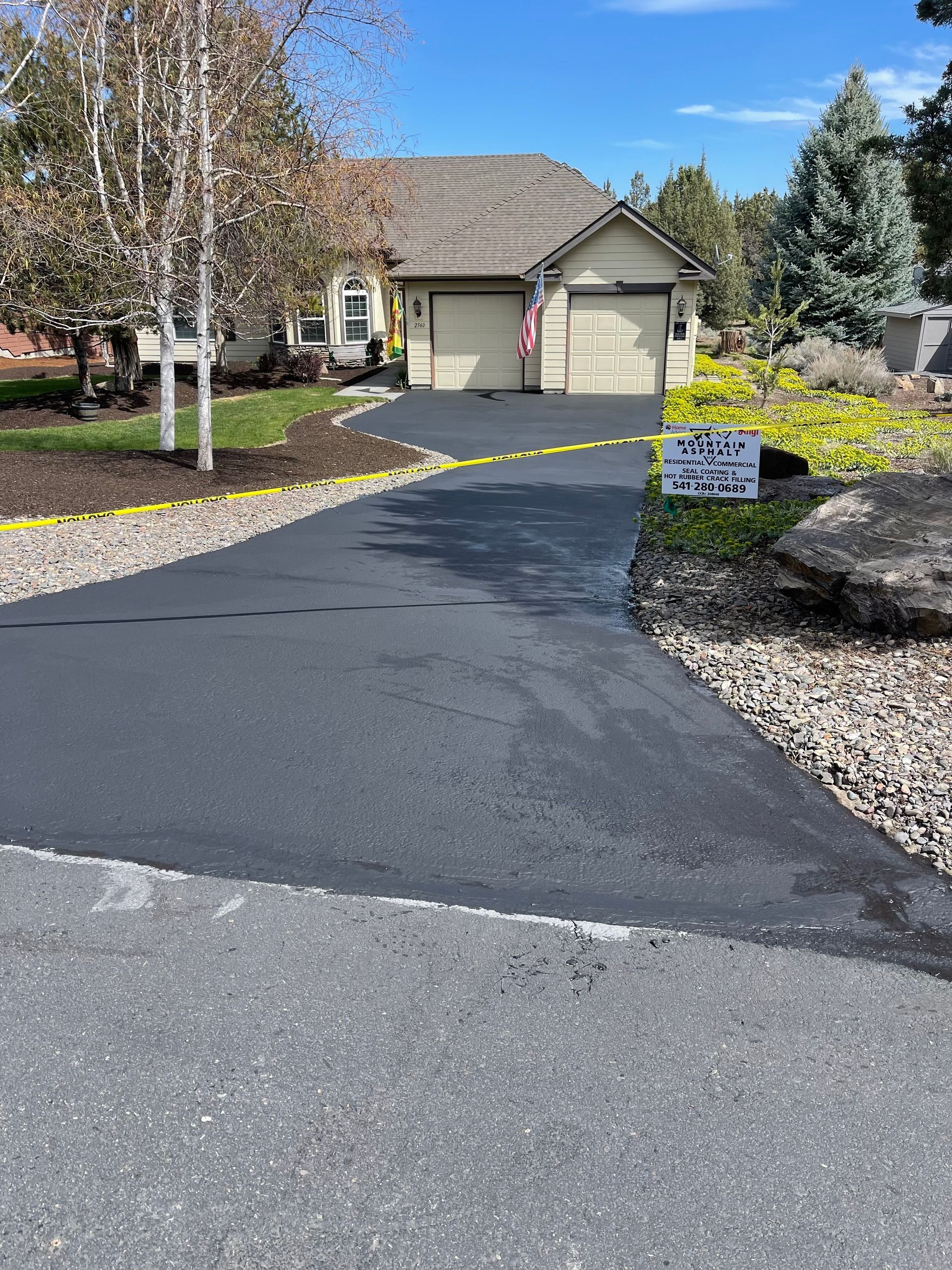 A driveway leading to a house with a sign that says ' i love you ' on it