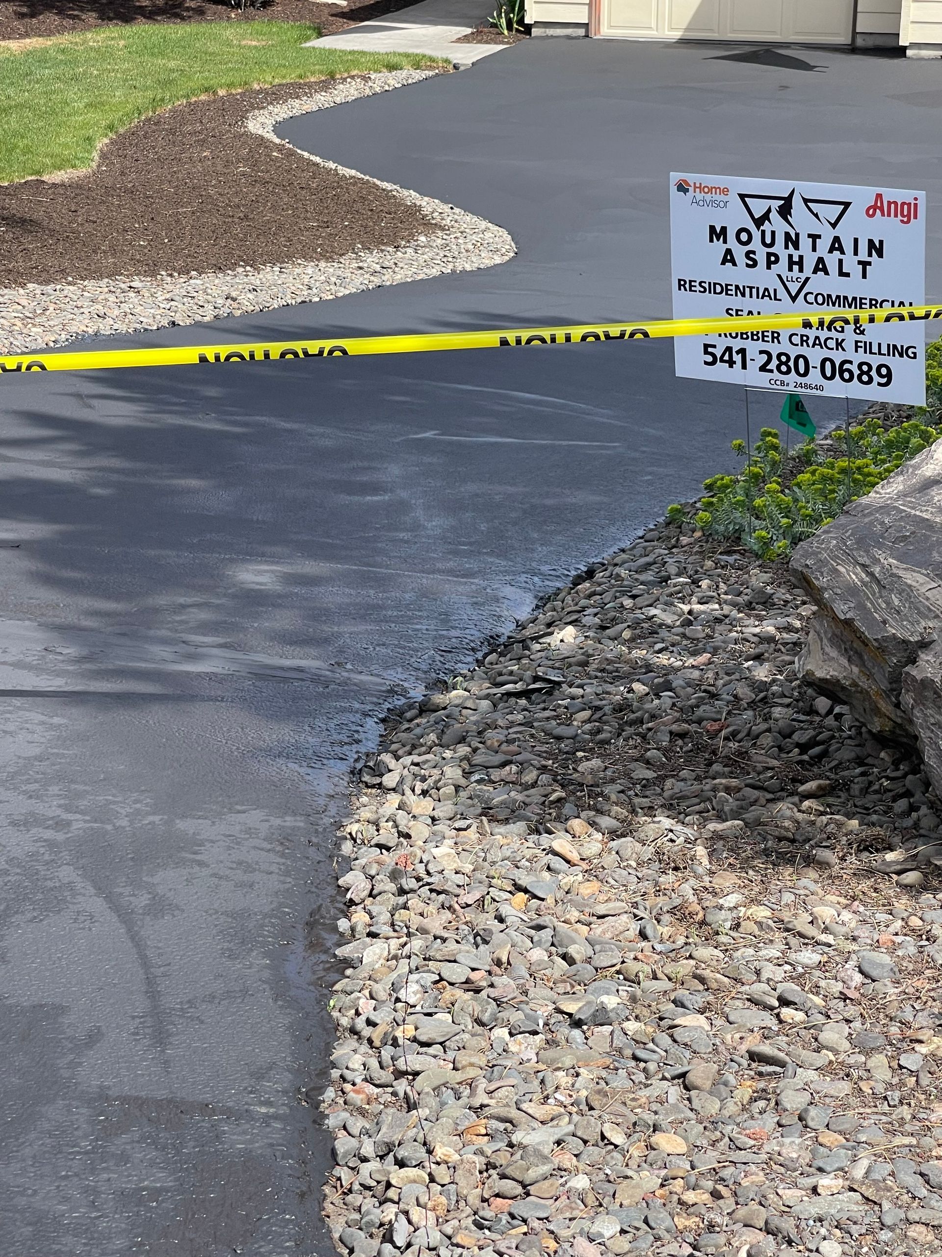 A sign on the side of a road that says mountain asphalt