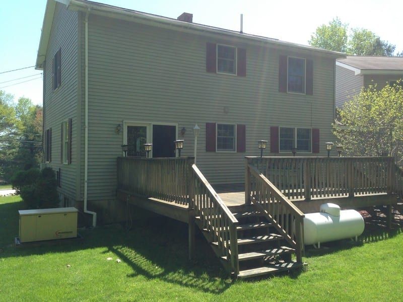 A large house with a large deck and stairs