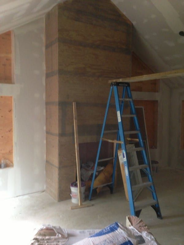 A blue ladder is in the middle of a room