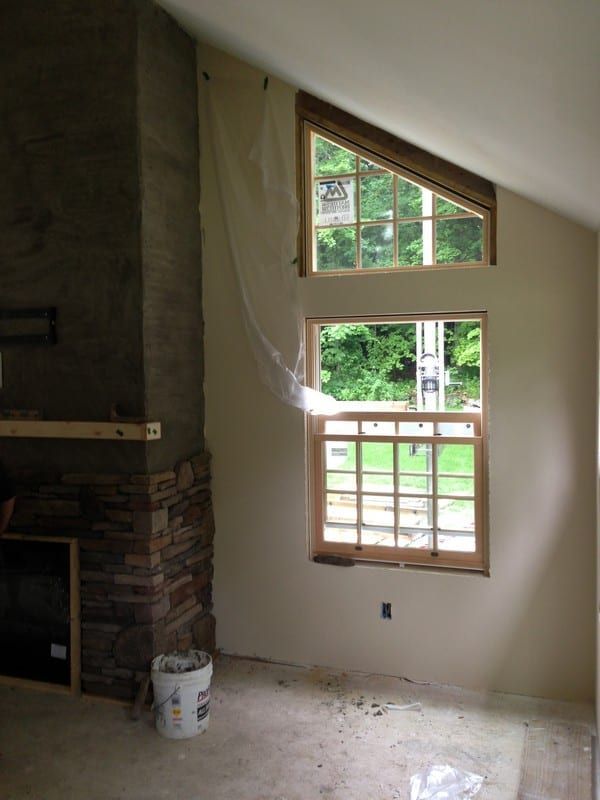 An empty room with a fireplace and a window