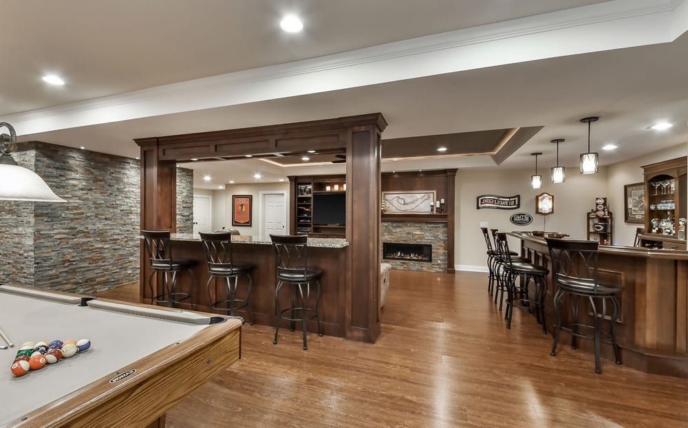 There is a pool table in the middle of the room.