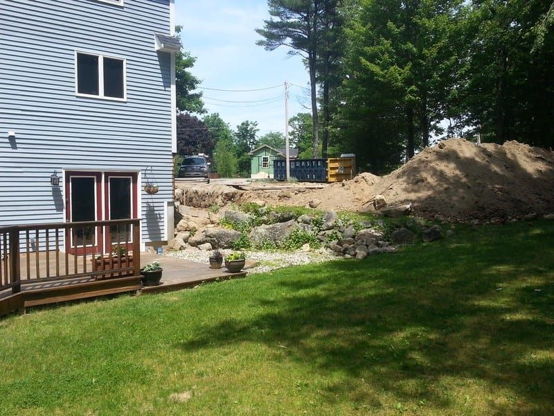 A house with a large pile of dirt in front of it