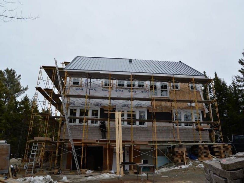 A large white house with a gray metal roof