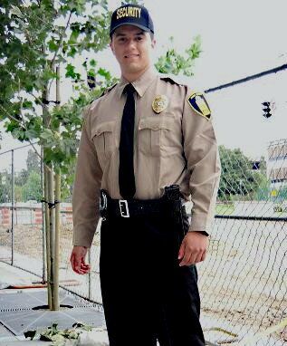 Security guard stationed in front of chain-link fence at San Diego construction site