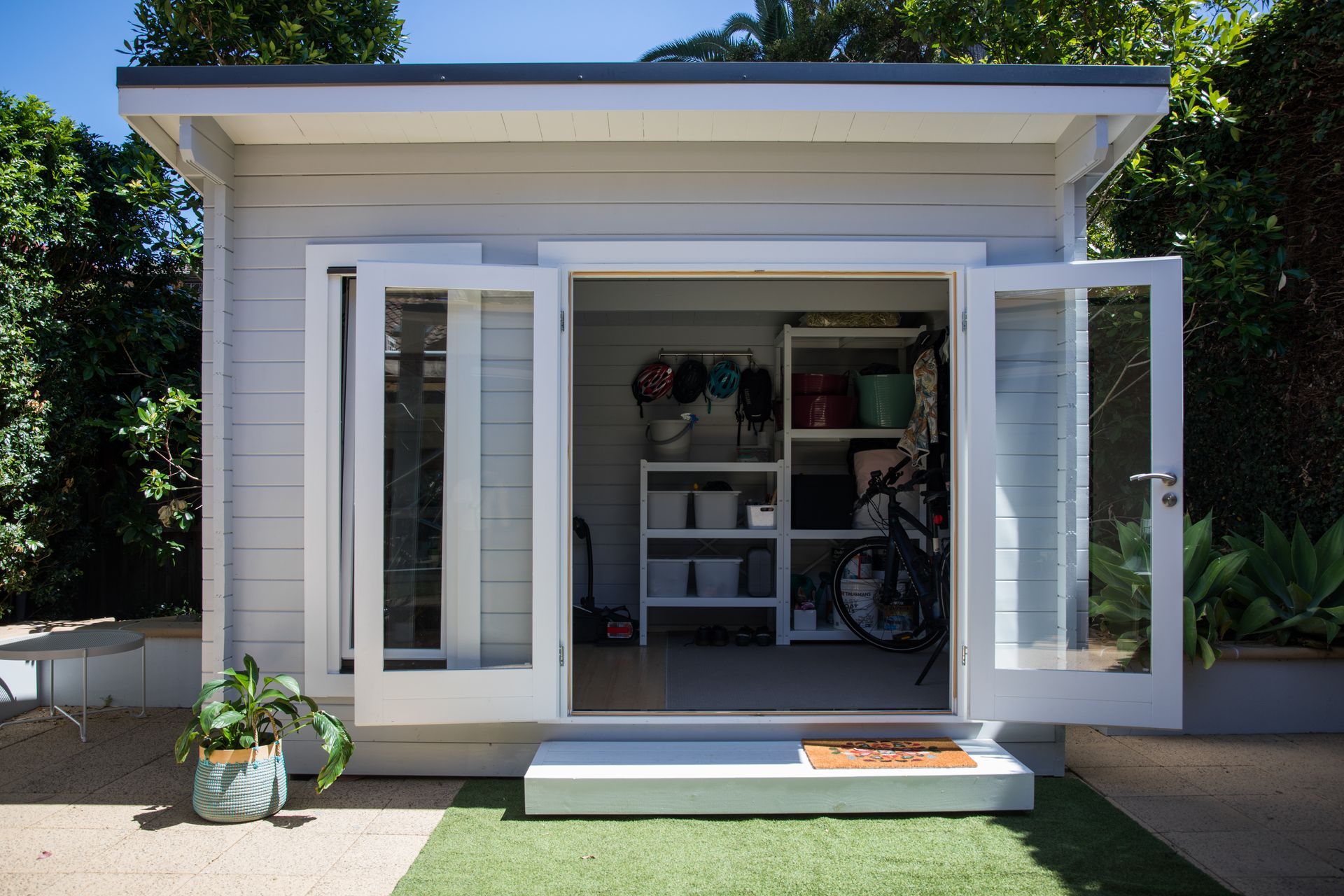 a white shed with the door open in suffolk county