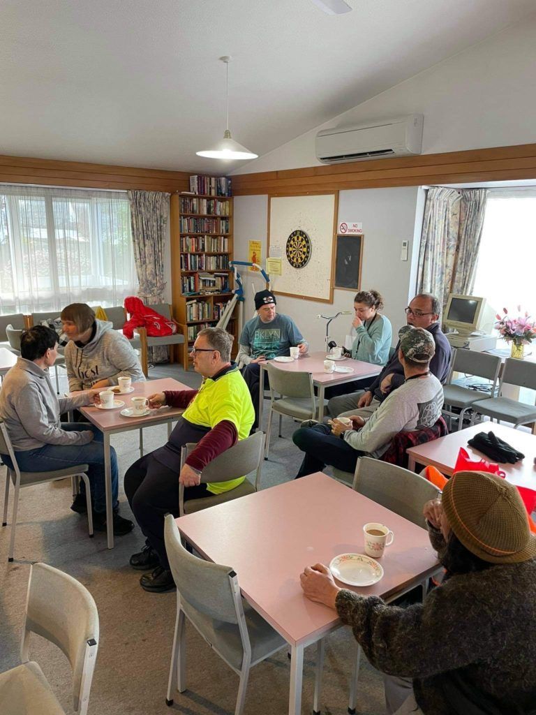 A group of people are sitting at tables in a room.